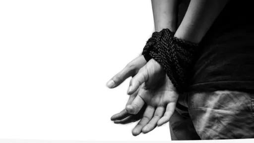 Man with hands tied